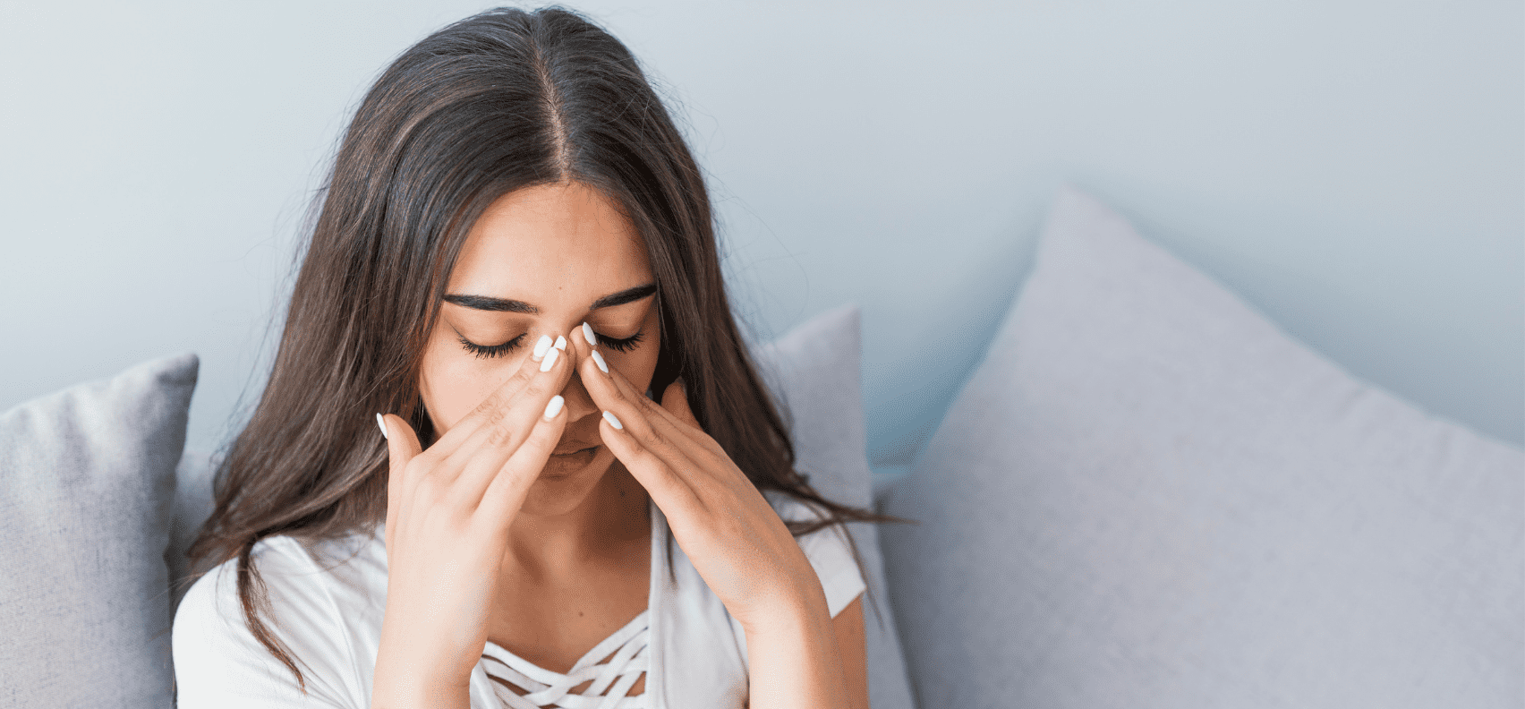 Woman feeling pressure on her face from sinusitis